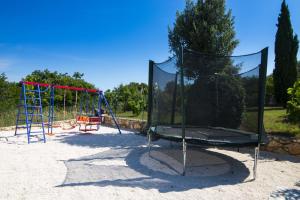 a playground with a swing set and a swing set at Meerblick Ferienhaus Julian nahe Rovinj in Rovinj