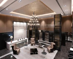 a lobby with a chandelier and a table and chairs at Aliz Hotel Times Square in New York