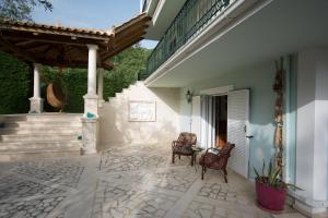 a patio with two chairs and a table on a house at Tatiana Studio with Private Pool in Akrotiri