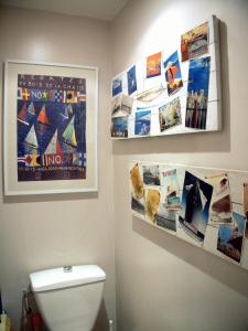 a bathroom with posters on the wall and a toilet at Appartement clair et lumineux au centre de Paris in Paris
