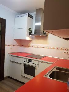 a kitchen with red counter tops and a sink at Suite Bucica in Teguise