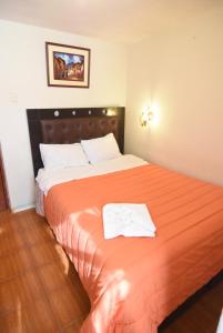 Rúm í herbergi á Tambo Cusco Inn