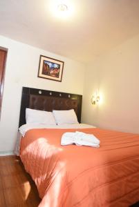 Rúm í herbergi á Tambo Cusco Inn