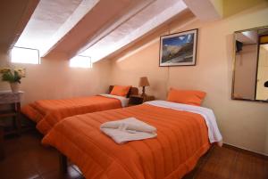 Rúm í herbergi á Tambo Cusco Inn