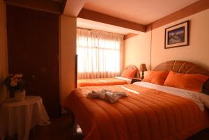 Rúm í herbergi á Tambo Cusco Inn