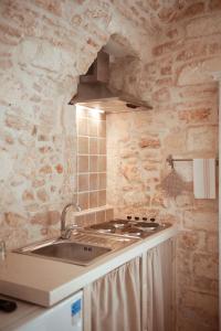 cocina con fregadero y fogones en Exclusive Apartments, en Martina Franca