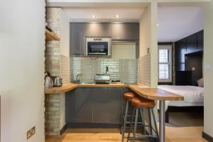 a kitchen with a sink and a counter top at Forbee Studios in London