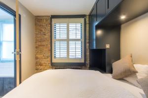 a bedroom with a large bed and a window at Forbee Studios in London