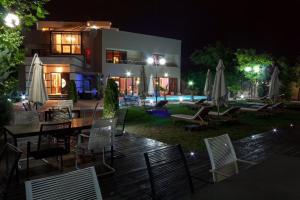 un gruppo di sedie e tavoli di fronte a un edificio di DREAM Party VILLA a Bucarest