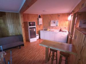 a kitchen with a table and a bench in it at Rio Lingue in Valdivia