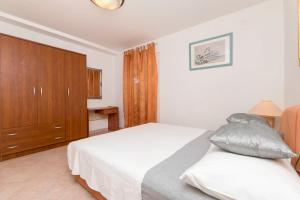 Postel nebo postele na pokoji v ubytování Apartments Slavomir