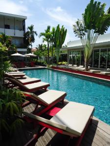 a swimming pool with lounge chairs and a resort at MEN's Resort & Spa (Gay Hotel) in Siem Reap