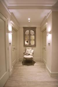 a hallway with a chair and a window at Hotel Villa Margherita in Quercianella