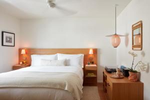 a bedroom with a bed and a lamp at Hotel Joaquin in Laguna Beach