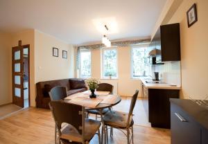 a kitchen and dining room with a table and chairs at Villa Gardena in Gdynia