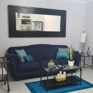 a living room with a blue couch and a table at Millsborough B&B in Billy Dun