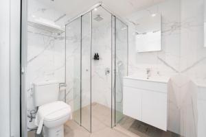 a white bathroom with a toilet and a shower at Heritage Collection on Chinatown - Mobile App Check-In in Singapore +20 photos