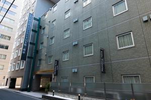 a building with signs on the side of it at Hotel Villa Fontaine Tokyo-Nihombashi Mitsukoshimae in Tokyo