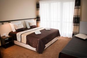 a hotel room with a bed and a window at Villa Gardena in Gdynia