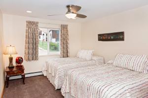 a bedroom with two beds and a window at Red Wing Motel in Manitou Springs