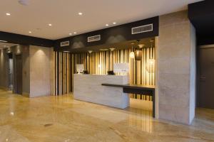 a lobby with a reception desk in a building at Hotel Cruz de la Victoria in Berrón