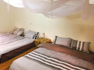 Postel nebo postele na pokoji v ubytování Bao Loc Homestay