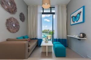 a living room with a couch and a window at Azur Paradise in Grand Baie