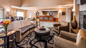 a living room with couches and a fireplace at Best Western Plus Blaine at the National Sports Center in Blaine