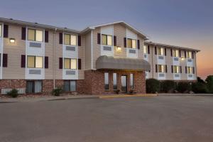 a building with a parking lot in front of it at Travelodge by Wyndham Jefferson City in Jefferson City