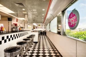 a fast food restaurant with stools in front of a counter at Travelodge by Wyndham Marysville in Marysville
