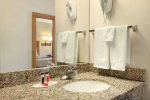 a bathroom with a sink and a mirror and towels at Travelodge by Wyndham Marysville in Marysville +11 photos