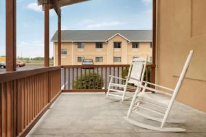 two chairs on a balcony with a building at Travelodge by Wyndham Marysville in Marysville