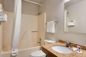 a bathroom with a sink and a toilet at Travelodge by Wyndham Jefferson City in Jefferson City
