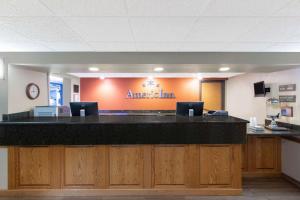 an office lobby with a large black counter top at AmericInn by Wyndham Cedar Falls in Cedar Falls