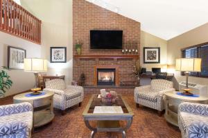 a living room with couches and a fireplace at AmericInn by Wyndham New London in New London
