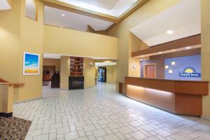 a lobby of a hotel with a reception desk at Days Inn by Wyndham Tulsa Central in Tulsa