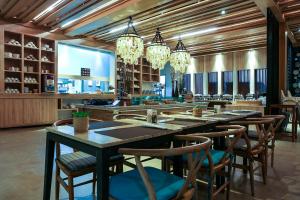 a large dining room with a long table and chairs at AKIRA Lipe Resort in Ko Lipe