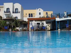 a large swimming pool in front of a hotel at Kalimera Hotel in Akrotiri