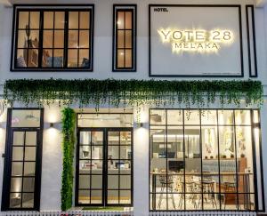 a store front with windows and ivy at Yote 28 in Melaka