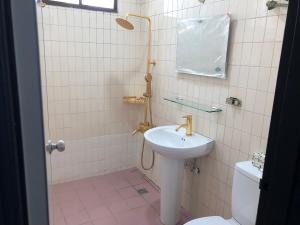 a bathroom with a sink and a toilet at Xiang Pin Hotel in Hualien City