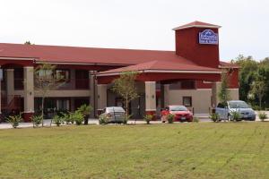 a building with cars parked in front of it at Atlantis Inn Suites in Houston