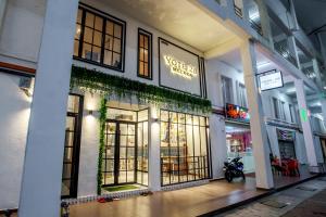 a store front with glass doors and ivy at Yote 28 in Malacca