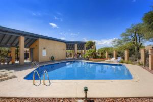 a large swimming pool in the middle of a yard at Camino los Mochis in Tucson