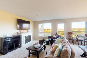 a living room with a couch and a television at Westhaven Park View in Westport