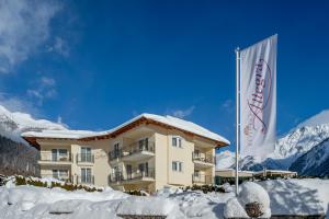 a hotel with a flag in the snow at Residenz Allegra in Sölden