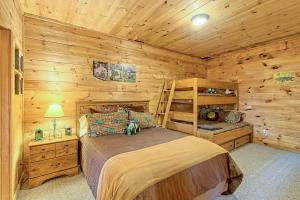 a bedroom with a bed in a log cabin at Sunset Valley in Ellijay