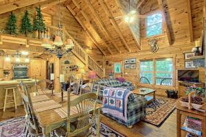 a dining room and living room in a log cabin at Sunset Valley in Ellijay