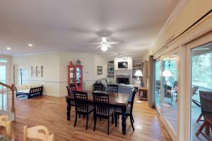 a dining room and living room with a table and chairs at The Green Ocean in Kiawah Island