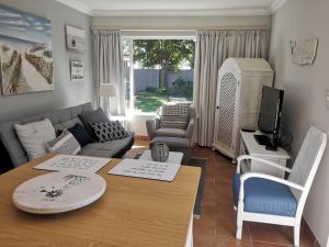 a living room with a couch and a table at On Cloud 9 in Hermanus
