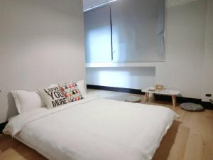 Llit o llits en una habitació de Xiang Pin Hotel